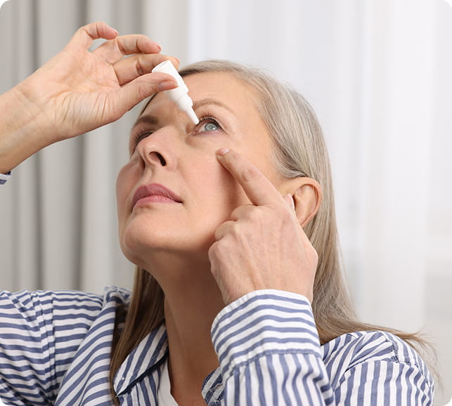 Person applying eye drops, illustrating a common management step for dry eye relief.